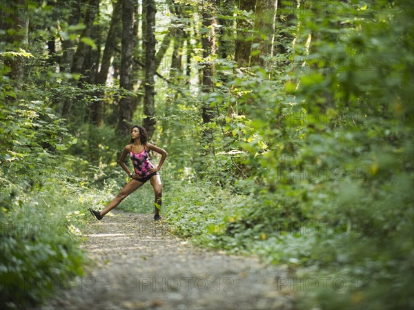 Young women stretching in forest. USA, Oregon, Portland.