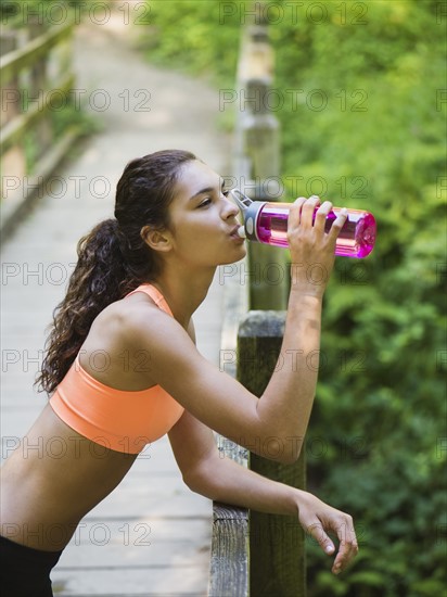 Young women resting, drinking water. USA, Oregon, Portland.