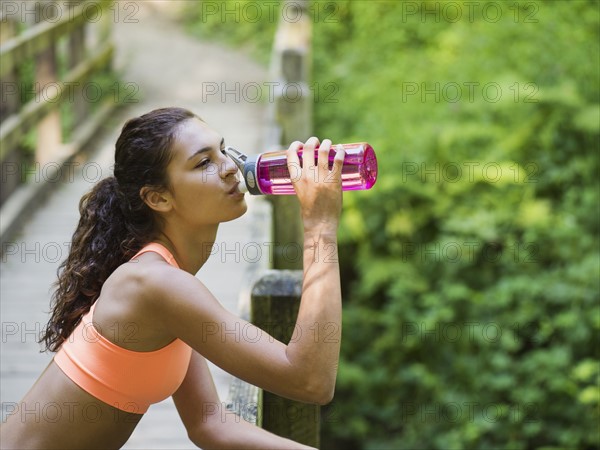 Young women resting, drinking water. USA, Oregon, Portland.