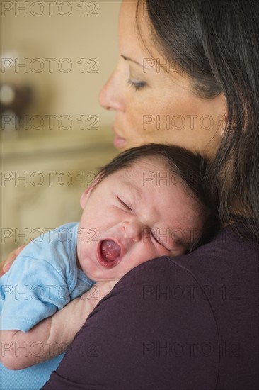 Portrait of mother holding newborn baby (0-11 months).