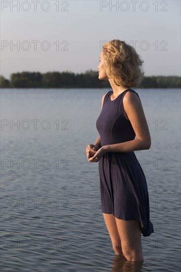 Beautiful woman standing in lake. Netherlands, Gelderland, De Rijkerswoerdse Plassen.
Photo : Jan Scherders