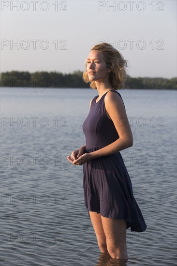 Beautiful woman standing in lake. Netherlands, Gelderland, De Rijkerswoerdse Plassen.
Photo : Jan Scherders