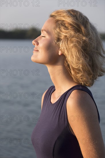 Beautiful woman with closed eyes standing in lake. Netherlands, Gelderland, De Rijkerswoerdse Plassen.
Photo : Jan Scherders