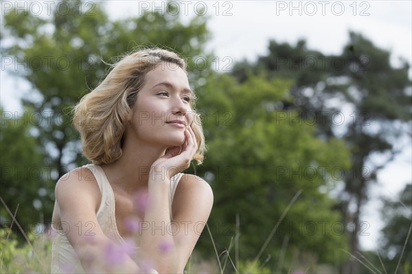 Woman relaxing on meadow. Netherlands, Gelderland, Hatertse Vennen.
Photo : Jan Scherders