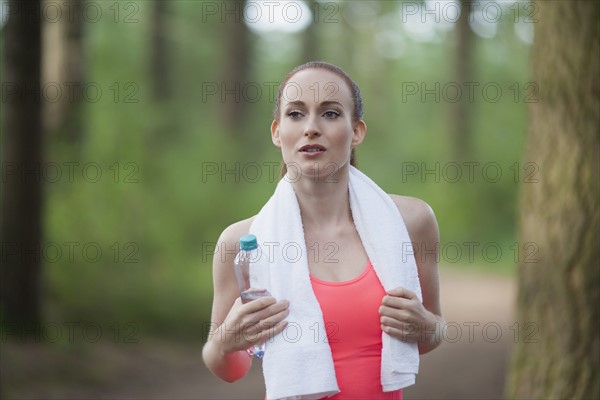 Portrait of woman holding bottle of water. The Netherlands, Erp.
Photo : Mark de Leeuw