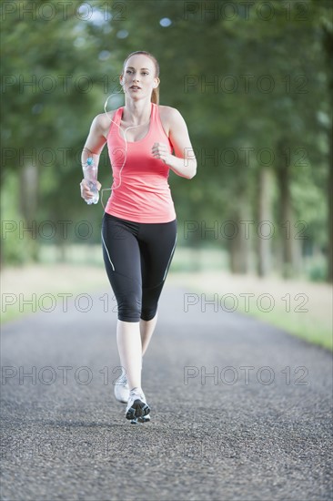 Woman jogging on road. The Netherlands, Erp.
Photo : Mark de Leeuw