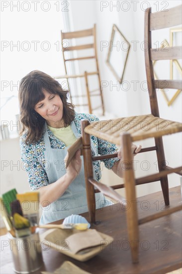 Woman restoring antique furniture.