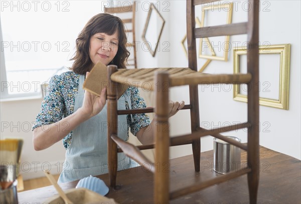 Woman restoring antique furniture.