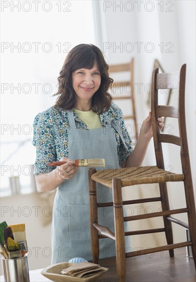 Woman restoring antique furniture.