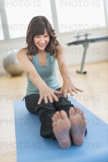 Woman stretching in gym.