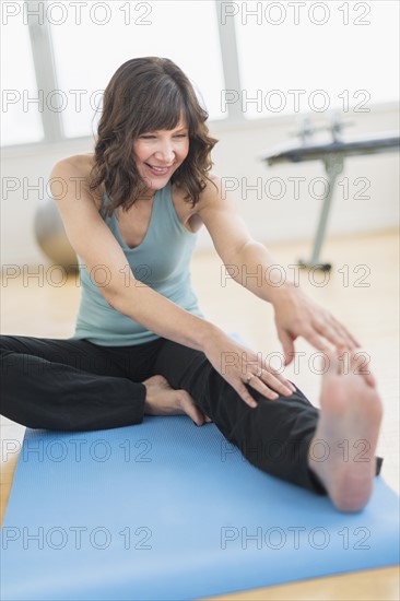 Woman stretching in gym.