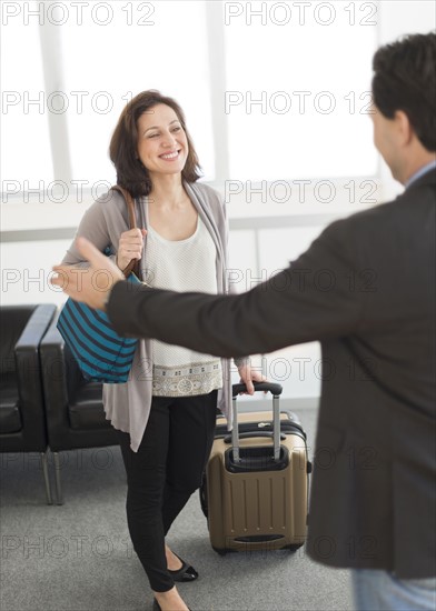 Couple meeting at airport.