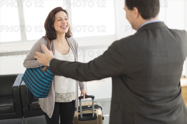 Couple meeting at airport.