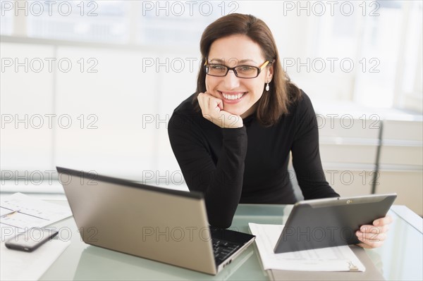 Portrait of businesswoman working in office.