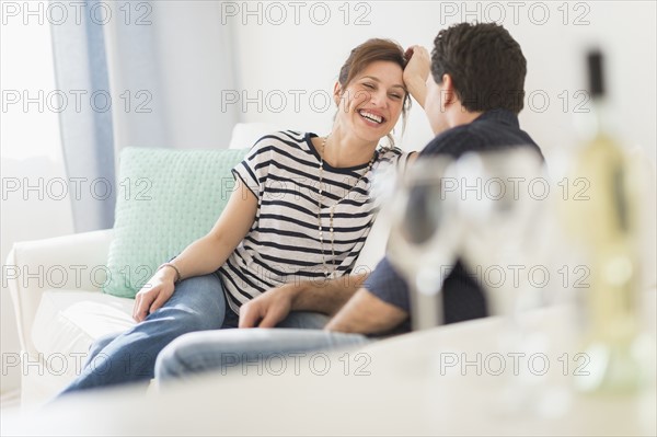 Couple sitting on sofa.