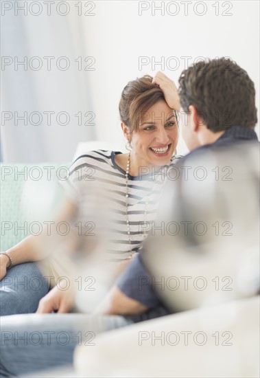 Couple sitting on sofa.