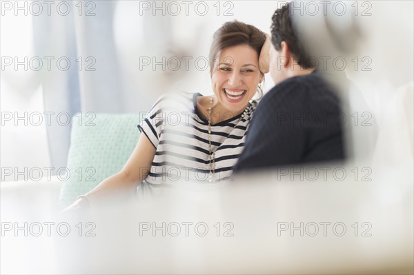 Couple sitting on sofa.