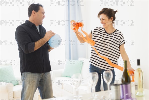Couple preparing party setting.