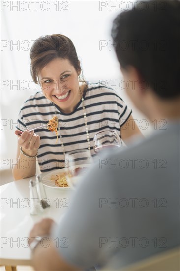 Couple eating spaghetti.