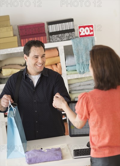 Customer paying in clothes store.