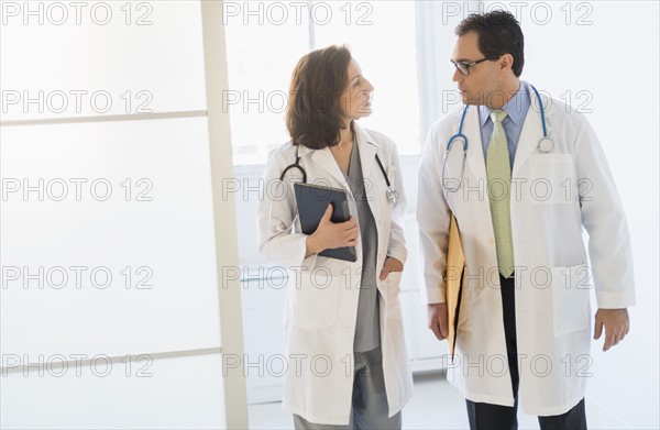 Two doctors talking in hospital.