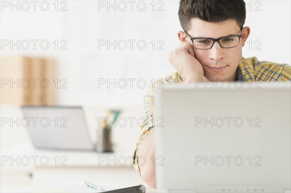 Young man using computer.