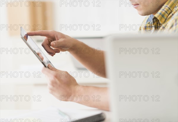 Young man using tablet.