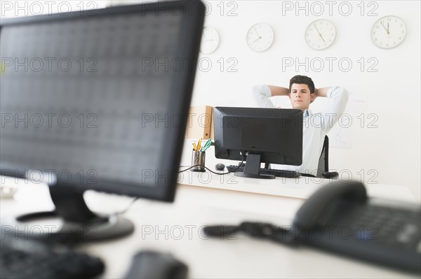 Young man sitting in front of desk and working.