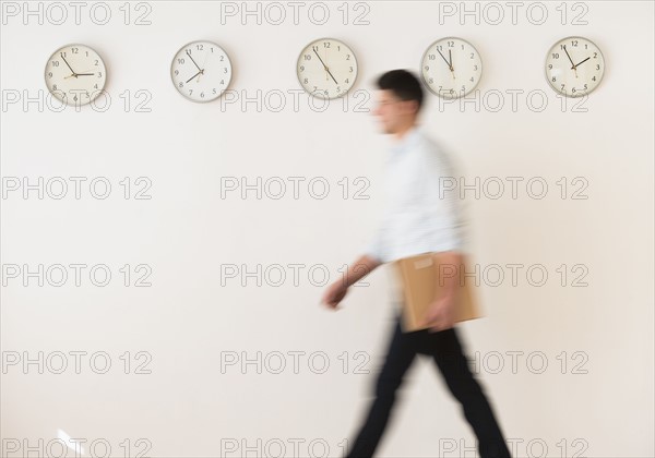 Young man walking with envelope.