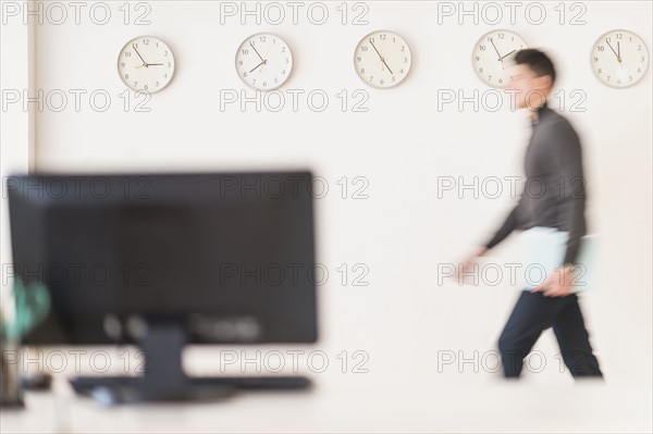 Young man walking with envelope.