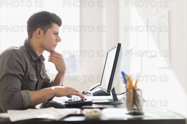 Young man using computer.