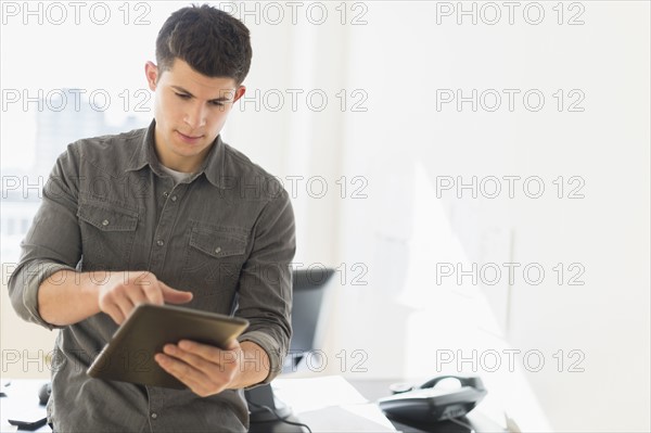 Young man using tablet.