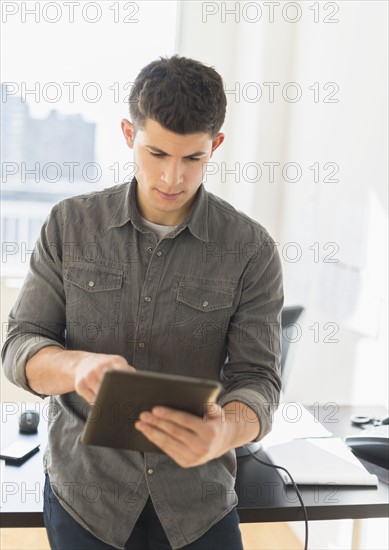 Young man using tablet.