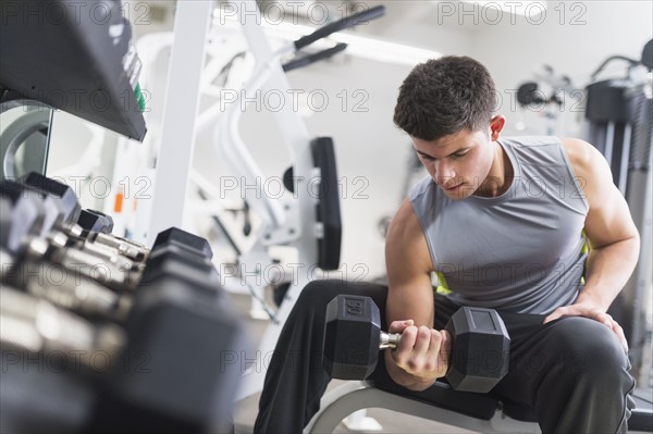 Young man working out at gym.
