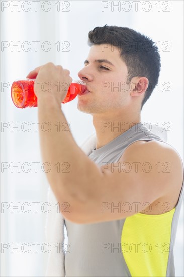 Young man drinking sports drink.