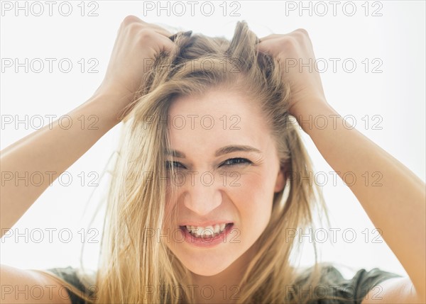 Frustrated woman pulling hair.
