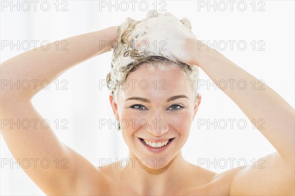 Beautiful woman washing hair.