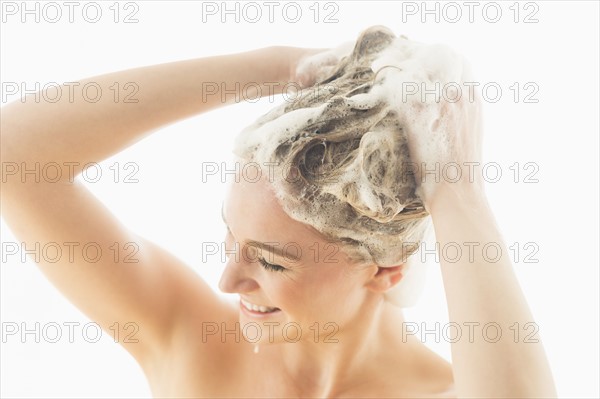 Beautiful woman washing hair.