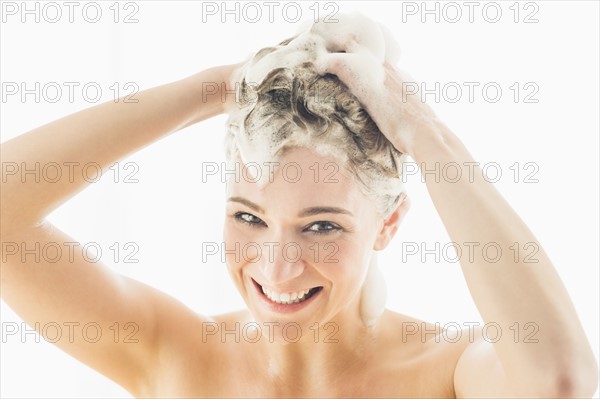 Beautiful woman washing hair.