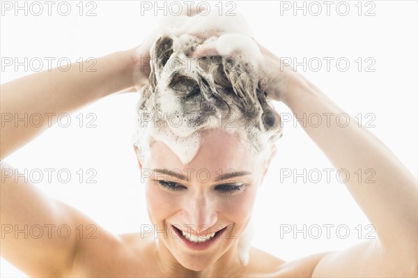 Beautiful woman washing hair.