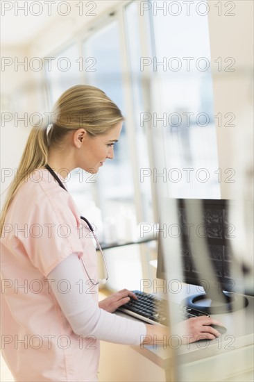 Female nurse working on computer.