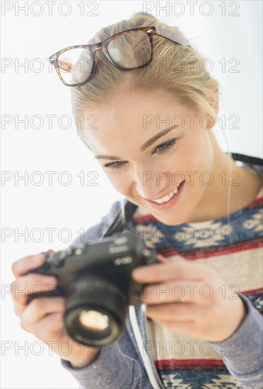 Woman taking picture with vintage camera.