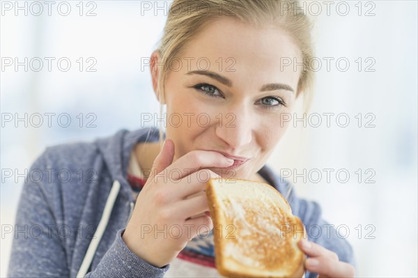 Woman eating toast.