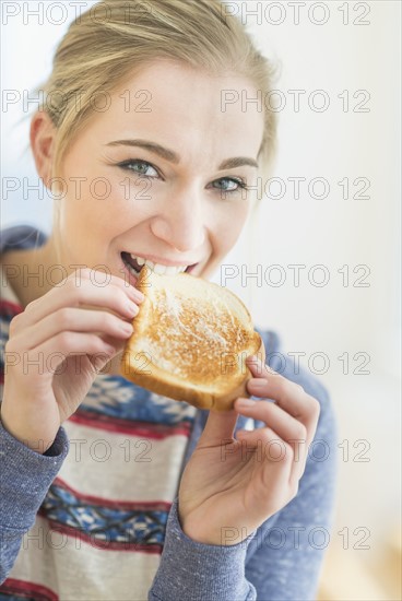 Woman eating toast.