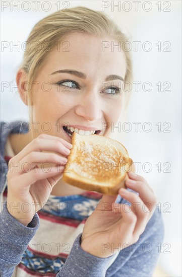 Woman eating toast.