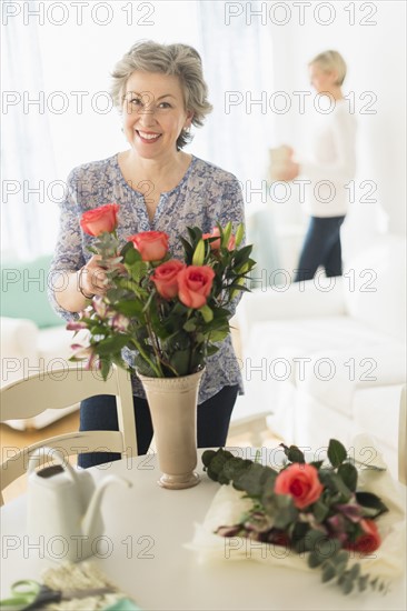 Woman arranging bouquet.