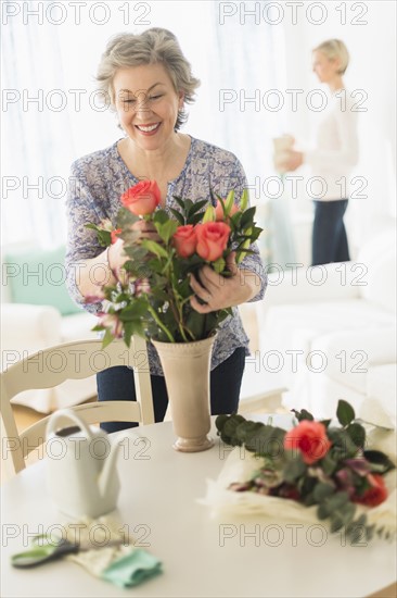 Woman arranging bouquet.