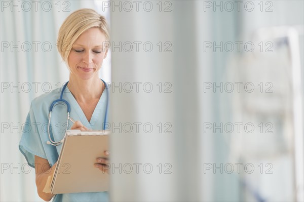 Female doctor doing notes.