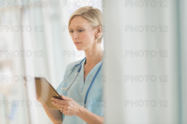Female doctor using tablet PC.