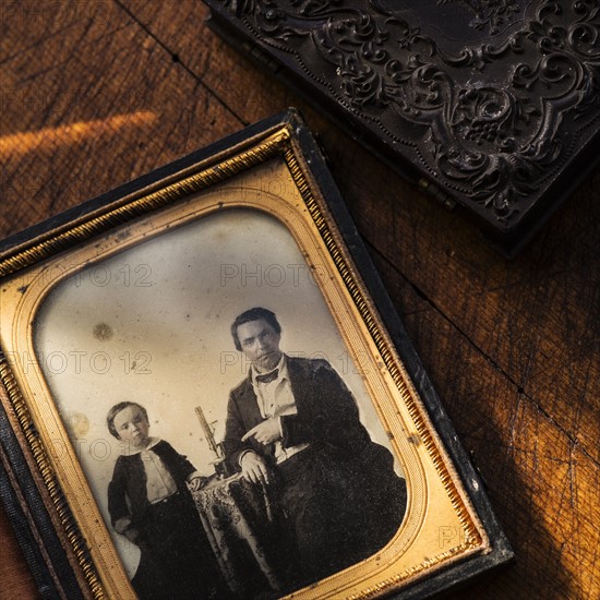 Studio shot of old fashioned photograph in picture frame.